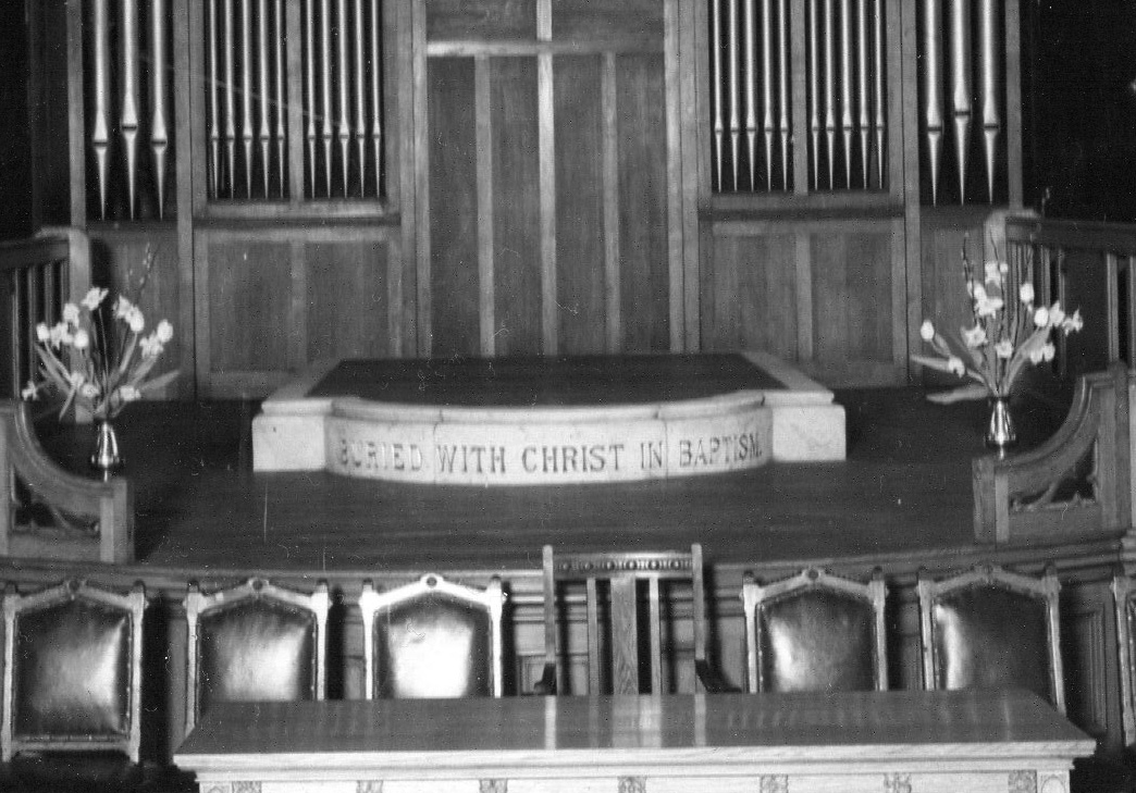 The original baptism pool with the inscription Buried with Christ in Baptism, in the early days of the church